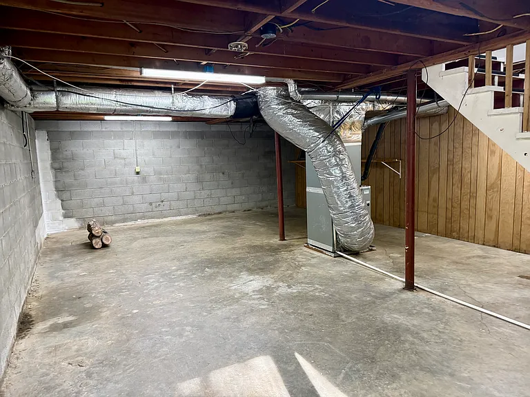 Again not a particularly beautiful space but important space. This is the other side of the unfinished space in the basement. It is dry and lit. A great place to store your Christmas decorations or anything else that you just may need extra space for.