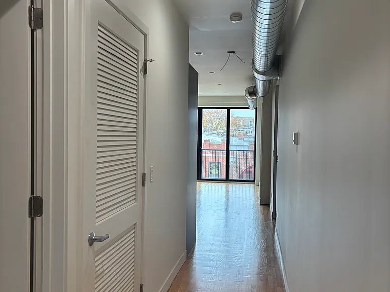 Hallway into the living space, washer/dryer to the left