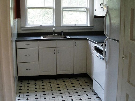 Overlooking the back yard that's bordered with woods, the kitchen has lots of cabinets and will soon feature a new DW, countertops and stainless steel gas stove.