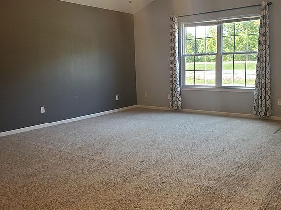 Large living room with vaulted ceiling and ceiling fan