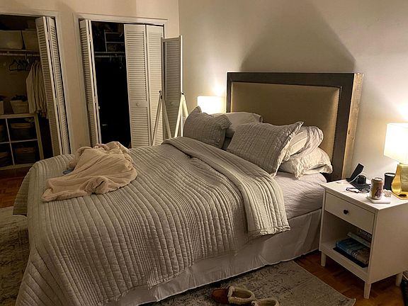 Bedroom with large closet. Bed faces windows that allow lots of natural light.