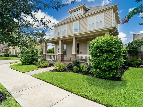 A large covered front porch area beckons you to sit and enjoy your morning coffee and wave to the neighbors as they stroll by!