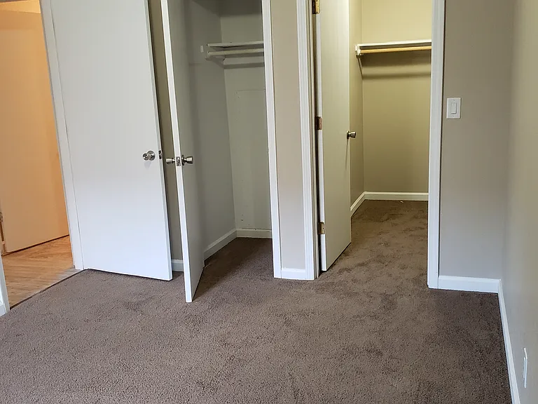 Master bedroom with walk in closet and small coat closet