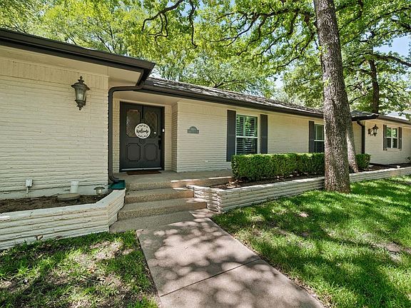 Entrance to property featuring brick siding and a yard