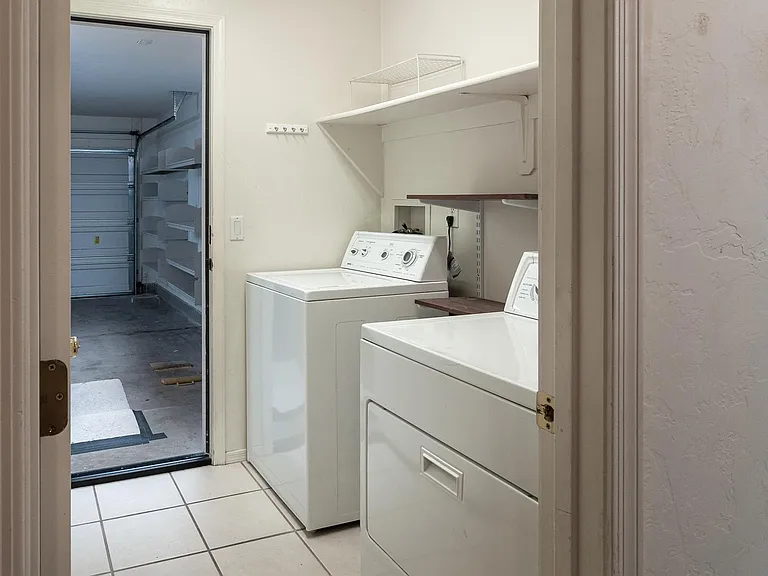 washer / drier / towel racks; backdoor to garage