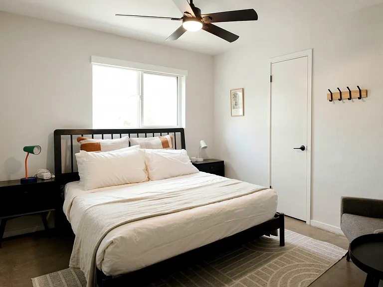 Comfortable bedroom with queen bed and clean, modern finishes.