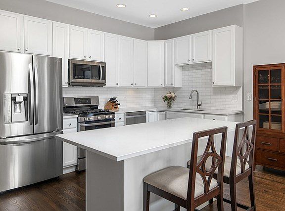 Recently renovated kitchen with quartz counters, 42 inch cabinets, and stainless steel appliances