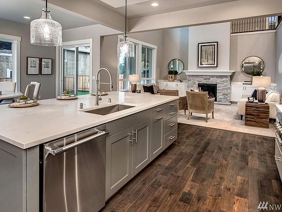 Photos are of a similar plan; details will vary due to builder and buyer options. All of Foxwoods' homes will include 48" Thermador Pro-Series Range and Hoods, side-by-side refrigerator/freezer, stacked cabinets w/crown extending up to the 10' ceiling, 5 stain-options for cabinets as well as painted upgrade options.