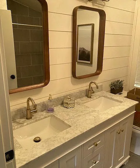 Hall bath double vanity, marble counter, shiplap wall