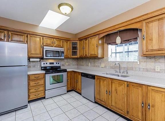 Kitchen with Quartz Countertops, Tile Back Splash and Ceramic Tile Flooring