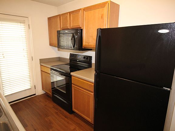 Kitchen features all black appliances, including over the counter microwave & smooth-top range.