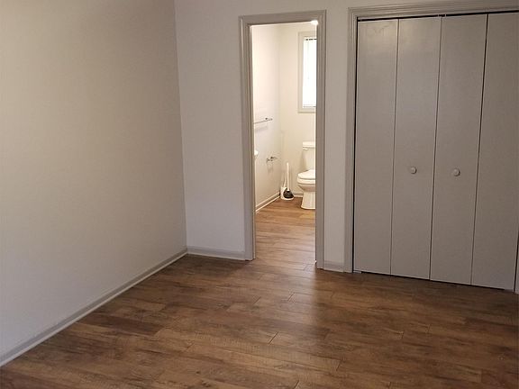 Bedroom with view into bathroom.