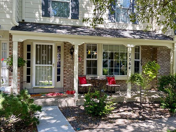 Front of townhouse; lovely covered front porch and bay window, green belt in front