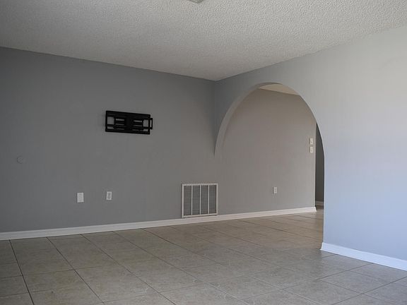 Large Living room, with beautiful archway and tv mount