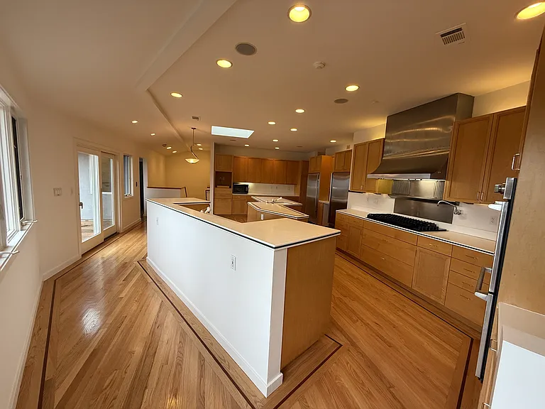 Chef's dream gourmet kitchen features two islands, freezer, refrigerator, two dishwashers, a pot-filler faucet and stainless-steel appliances.