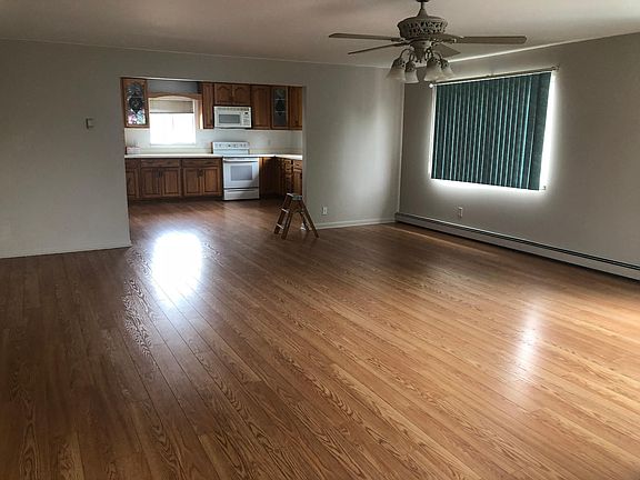Large living room with new flooring and freshly painted wall