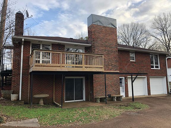 Back of the house with balcony and two car garage