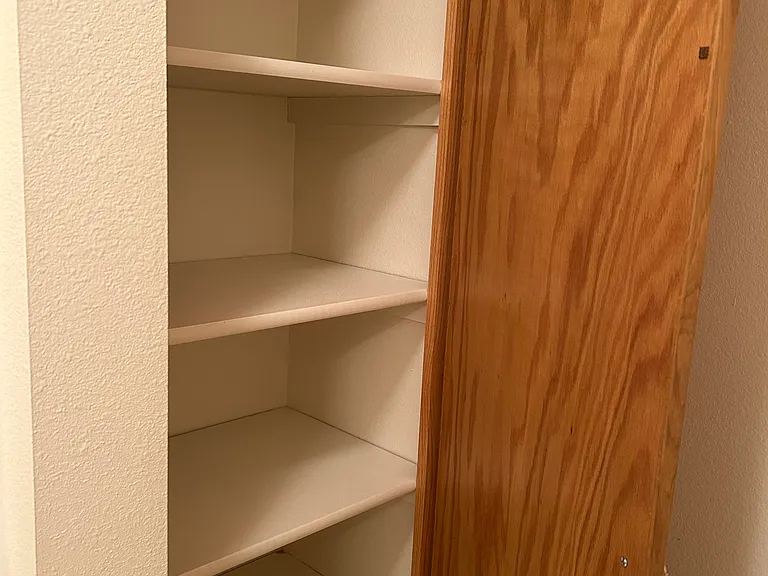Linen closet in private bathroom