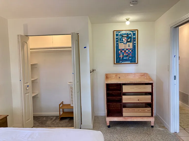The south bedroom's closet & dresser/shelves storage, w locking pocket door.