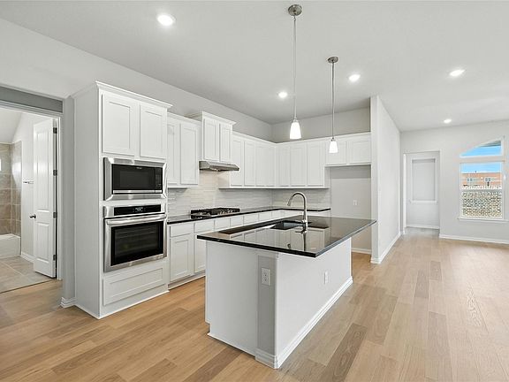 Another view of the kitchen towards back of home.Refrigerator is now in place.