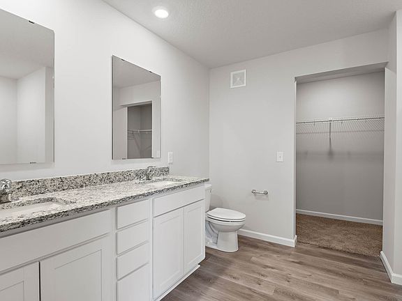 The master bathroom has a dual sink vanity.