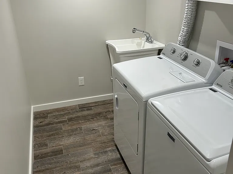 Laundry room with sink in the lower level.
