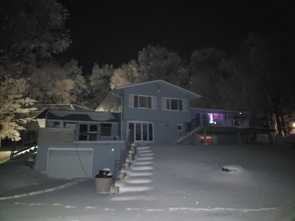 View of the duplex from the lake side. The window at the top of the steps leading from the lake to the property is the living room window of the apartment.