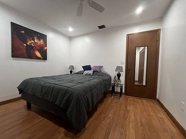 Bedroom 2 10x12 ceiling fan Queen bed with lift and massage features.