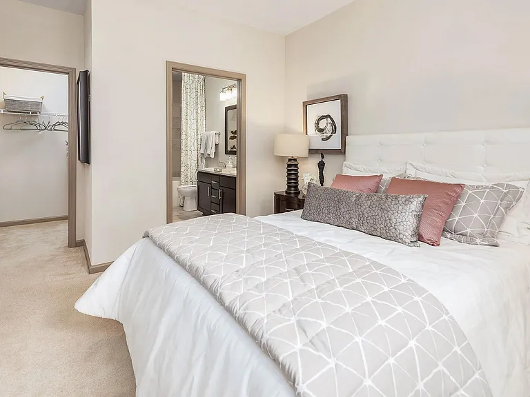 Spacious primary bedroom with large closet and en-suite bathroomcomfortable, modern apartment living in Charlotte.
