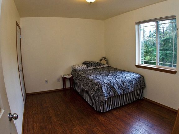 This upstairs bedroom was recently remodeled with new paint and wood flooring.