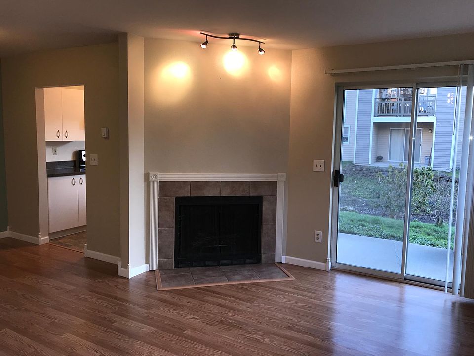 Living room, with kitchen door on left and sliding doors to patio on right.