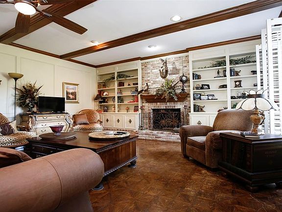 Large living area with built in bookcases and a gas log fireplace
