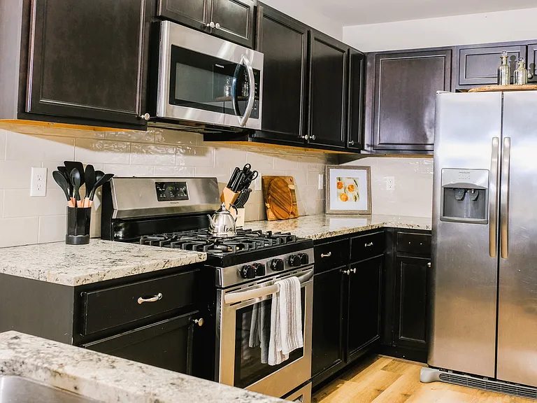 Gas range in fully stocked kitchen.