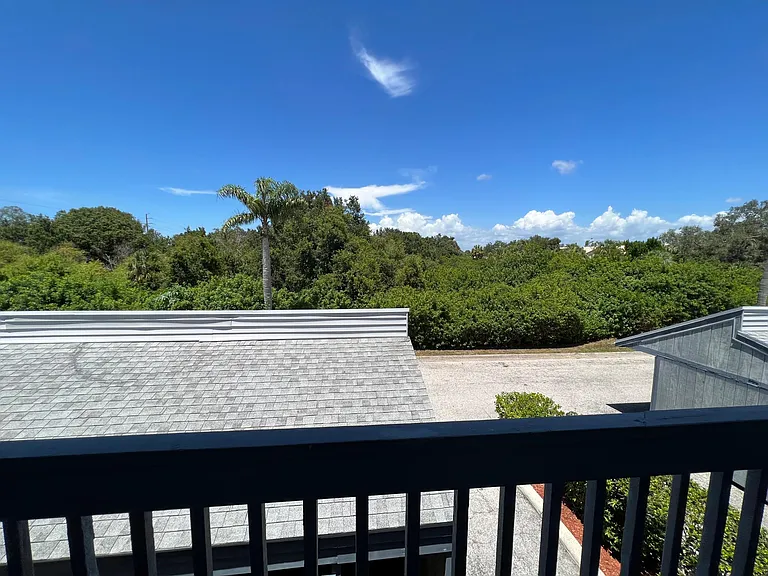 Front door view overlooking parking and nature preserve
