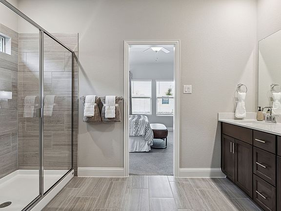 Primary bathroom with double vanity and large walk-in closet