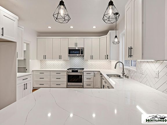 The kitchen cabinets are a grey color.