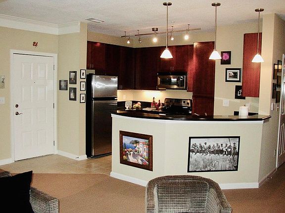 Kitchen with bar at front of photo.