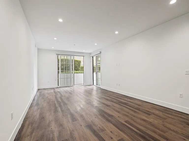Living Room with Recessed Lighting, Vinyl Flooring, and Patio with Custom Shades