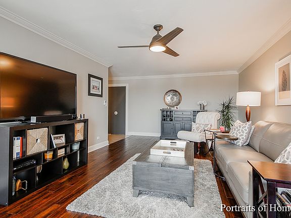 Spacious living room, with, Hardwood floors, crown molding, 5" base boards and a ceiling fan!