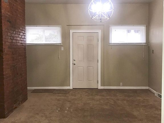 Living Room has been freshly painted, and been updated with new carpeting, new windows, new front door, and new chandelier!