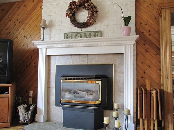 The gas insert will help heat the upstairs and is a focal point with the tile front and wooden mante