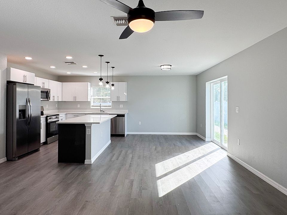 Great room with sliders to fenced-in backyard