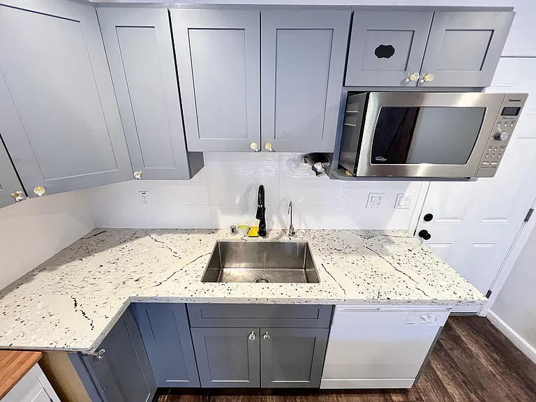 huge stainless steel sink, dishwasher, and microwave.