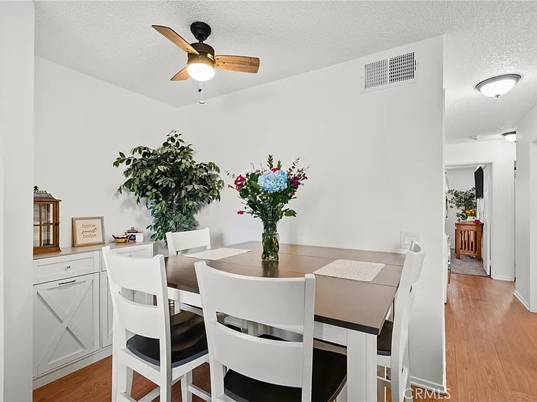 Dining room with view facing hall bathroom and primary bedroom at the end of the hallway