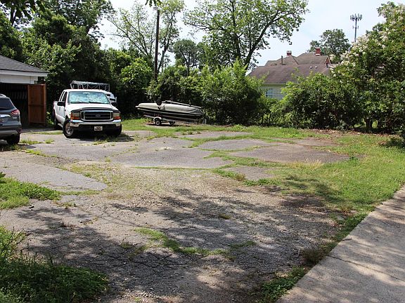 Rear parking area. Entrance to apartment is by stair to left of garage (outside of photo).