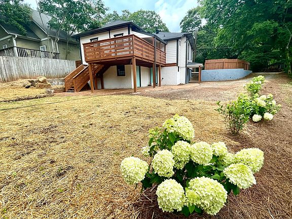 big back yard, sunny deck, beautiful garden with flowery hedges