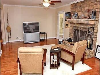 Den with gas fireplace, hardwood floors, open to kitchen and reading room