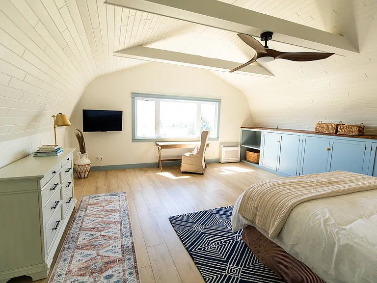 The master room includes a king size bed, built-in closet space, a dresser, a desk, and a smart TV