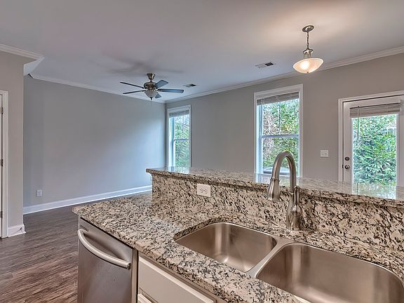 Kitchen overlooking the family and dining room for the Charleston house plan.