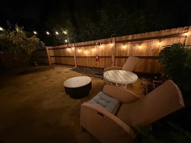 Fully enclosed yard with BBQ pit/ fire pit.